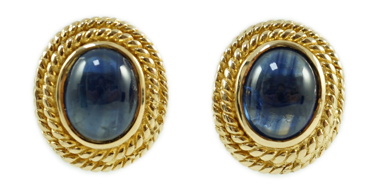 A 20th century pair of gold and cabochon sapphire set oval earrings